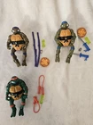 Vintage lot of 3 Teenage Mutant Ninja Turtle figures w/ Weapons Accessories