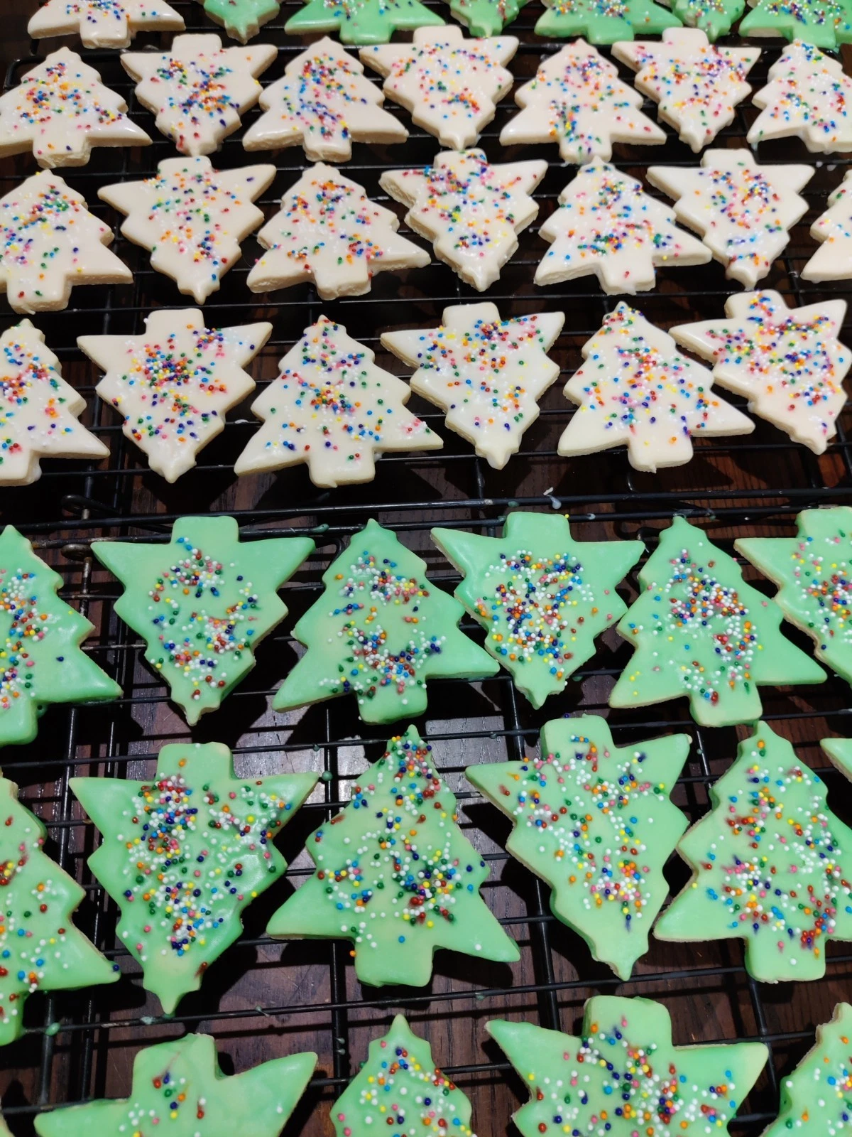Rows of homemade green and white Christmas Tree Sugar Cookies