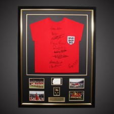11 Signed England Shirt Incl Sir Bobby Charlton , Plus Bobby Moore Signed Card.