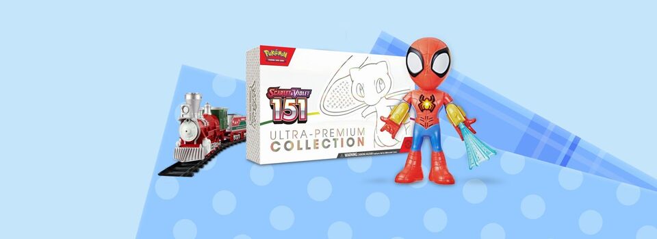 Three toys sit against a light blue background with wrapping paper designs. From left to right, A holiday-themed toy train on a track, a Pokémon Scarlet & Violet 151 Ultra-Premium Collection box set, and a Spidey and His Amazing Friends electronic Suit Up Spidey.