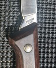 Vintage Western fish fillet knife with steel blade, wooden handle, brass screw, and silver engraving reading “W.E.S.T.ERN U.S.A.”