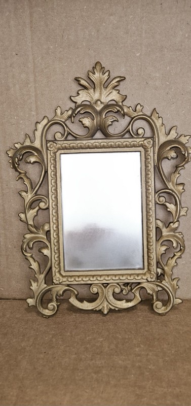 Vintage-style vanity mirror features a gold-finished cast iron frame