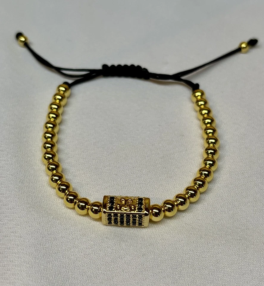 Pulsera unisex oro laminado 18k con dije rectangular negro Foto 3 de 3