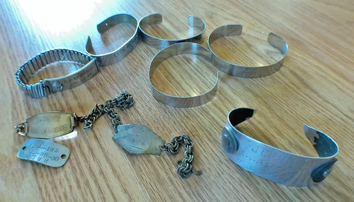 9 MILITARY RELATED BRACELETS,  WW2 - VIETNAM P.O.W.