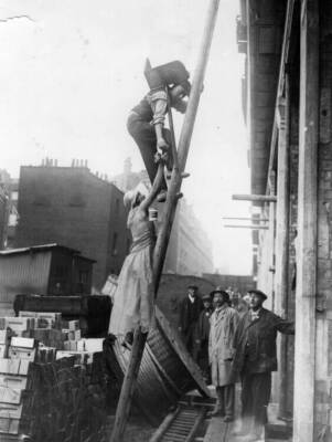 On Alexandra Rose Day rose seller climbs ladder to encourage brickl- Old Photo