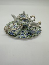 Miniature tea Service set Accented with blue floral and green leaves.