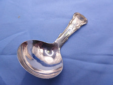AN ANTIQUE STERLING SILVER SHELL PATTERN CADDY SPOON.BIRMINGHAM 1853.