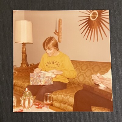 FOUND VINTAGE PHOTO PICTURE 70s Guy Opening Gift In Front Of Spike Clock 1977