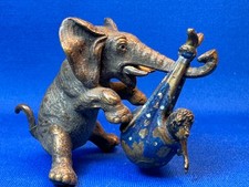 Vintage Vienna Bronze Elephant holding a child in a blue blanket