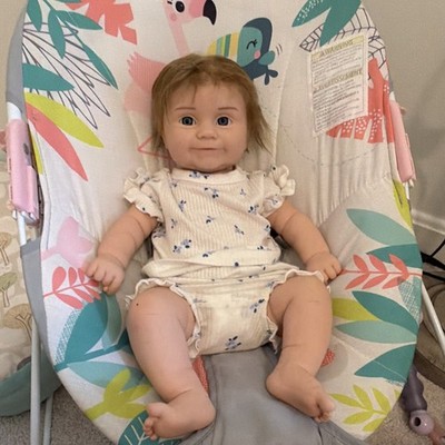 Reborn silicone baby doll Maddie sculpt rooted hair.
