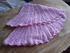 A new hand crochet baby circular shawl made in  dark pink 4ply yarnoi