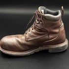 Red Wing 2212 steel toe work boot with brown laces, dark heel panel, and visible “Made in U.S.A.” text on black sole.
