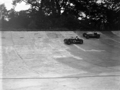 A Bugatti chases after another car on the banking 1935 Motor Racing Old Photo