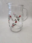 Vintage Anchor Hocking glass pitcher with a red rose pattern.
