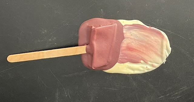 A vintage vinyl fake melting ice cream bar prop — the kind of tactile, perfectly-crafted visual prank that belonged in every 1970s joke shop window.