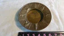 Old brass ashtray with symbols