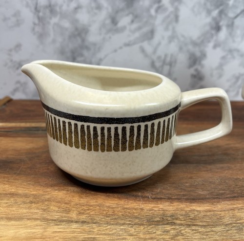 Cream LENOX Temper Ware coffee mug with black and gold vertical stripes, white handle, and “Made in U.S.A.” text on body.