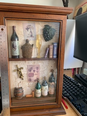 This is a decorative wine-themed diorama in a frame, also known as a ''shadow box
