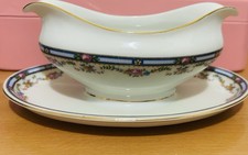 vintage porcelain gravy boat with an attached underplate.