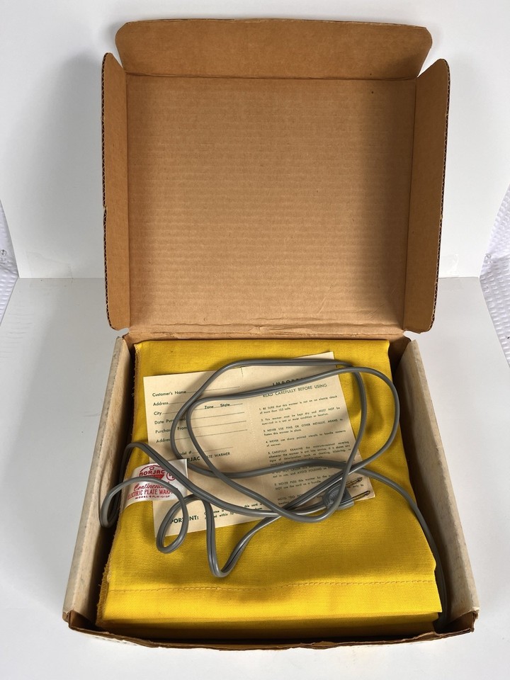 A sunny yellow 1950s electric plate warmer still in its original box — the kind of MCM kitchen artifact that looks amazing on a shelf AND actually works.