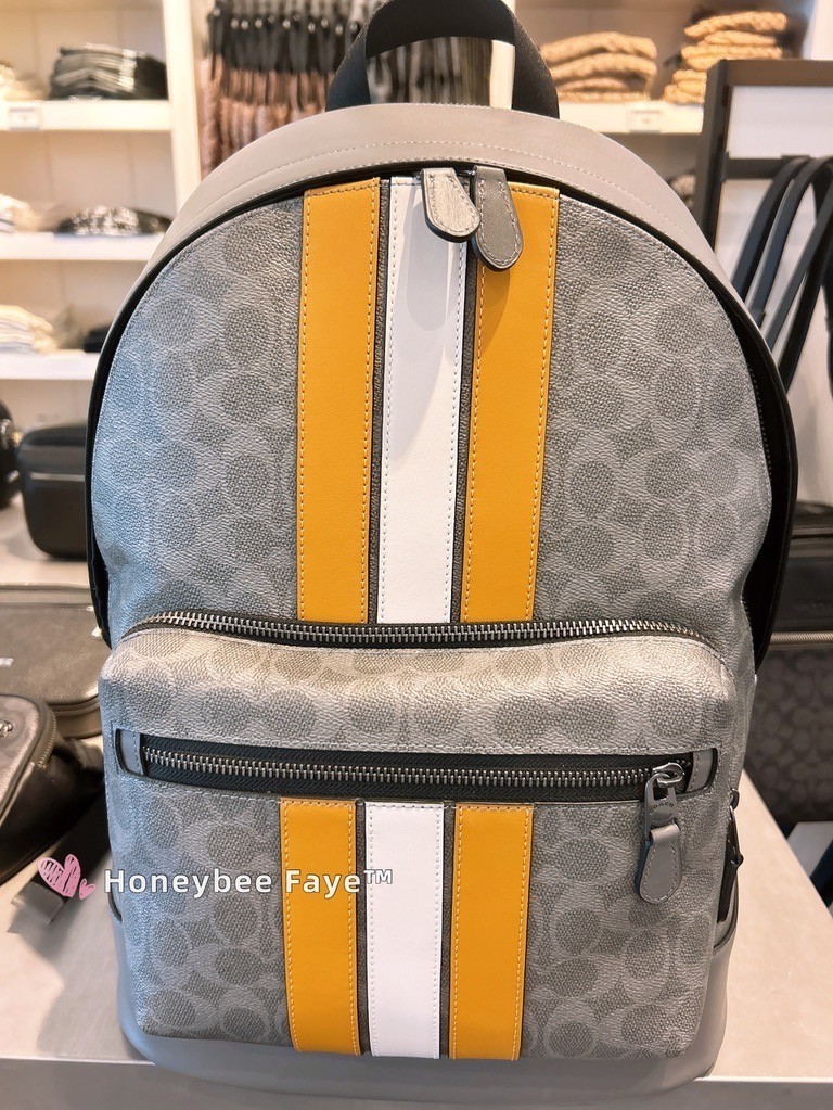 coach campus backpack with varsity stripe West Signature coated canvas and smooth leather Two separate main compartments with zip closures Inside zip cell phone and multifunction pockets Fabric lining Top handle with 3 1/4 drop Outside zip pocket Adjustable shoulder straps 12 1/2 (L) x 16 3/4 (H) x 6 (W) Style No. Coach West Backpack In Signature