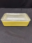 vintage Pyrex yellow 1.5-quart refrigerator dish with original ribbed glass lid.
