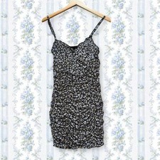 Black floral mini dress with ruched detailing and spaghetti straps