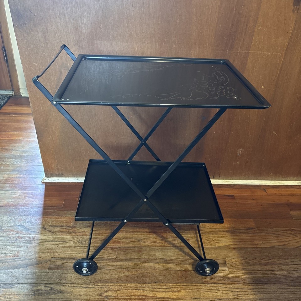 Vintage rolling/folding bar cart with an embossed grape motif — that decorative detail makes it a conversation piece, not just a cart.