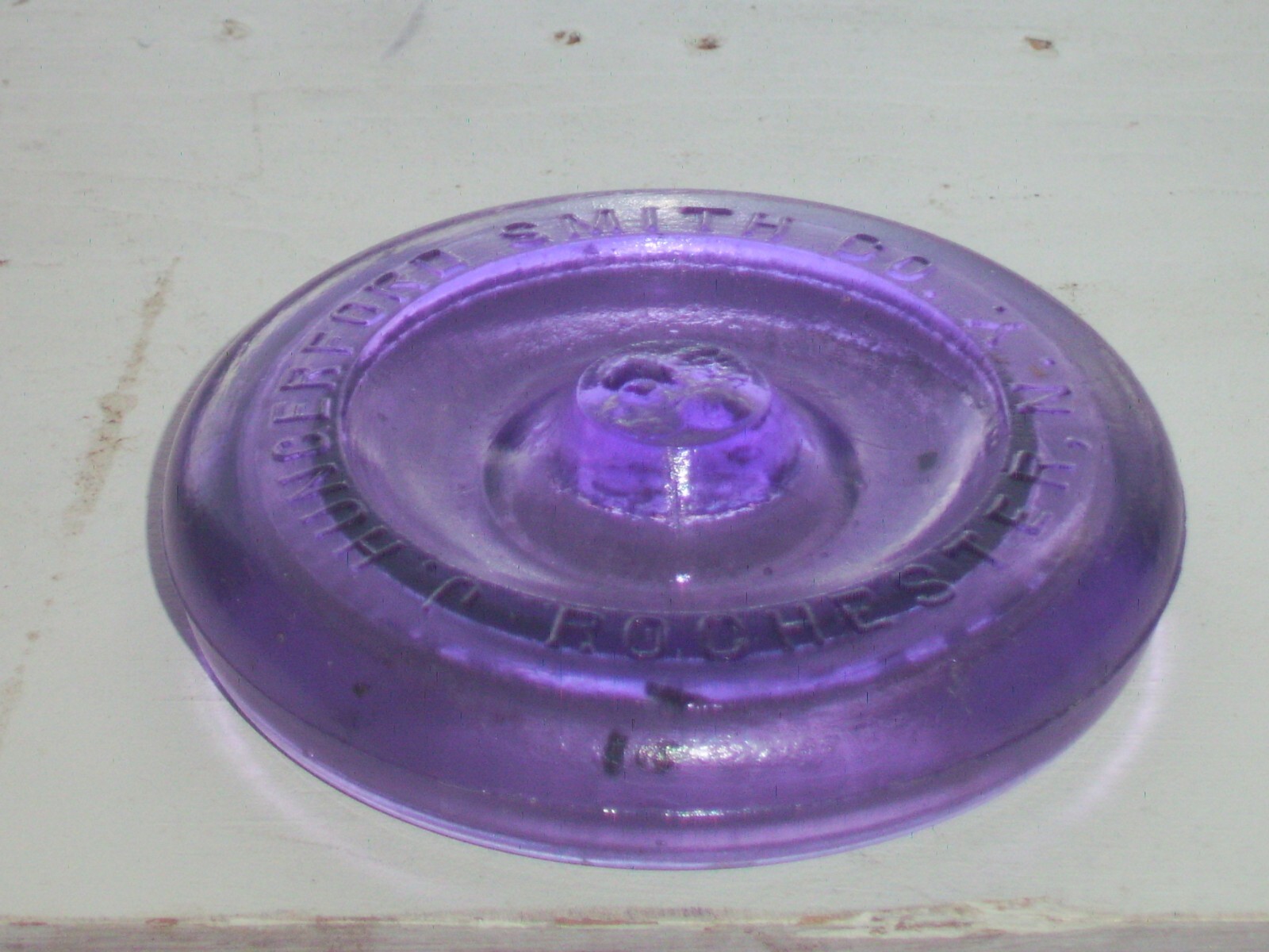 Dark purple J, Hungerford Smith co. Rochester, N. Y. glass top canning jar lid