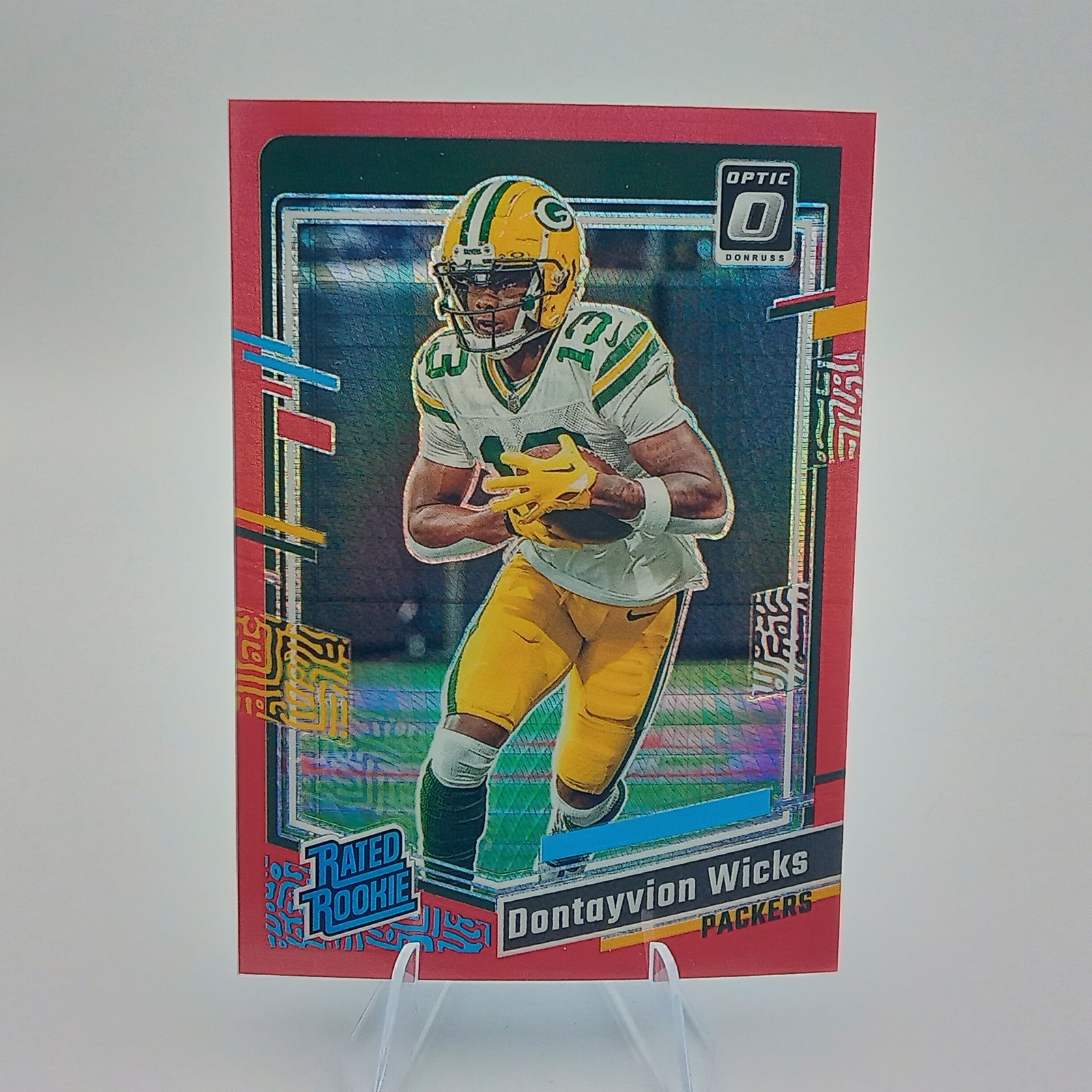 2023 Donruss Optic #249 Dontayvion Wicks Red Hyper Rookie