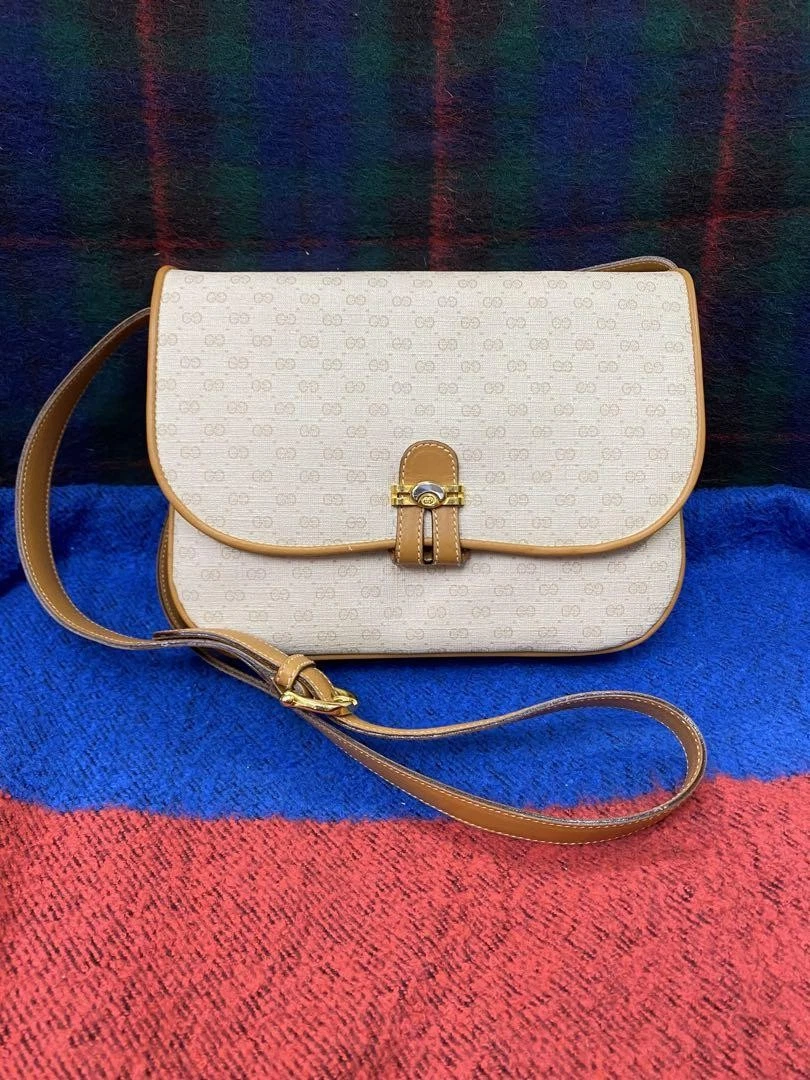 Sac à bandoulière Gucci vintage beige motif GG avec usure mineure