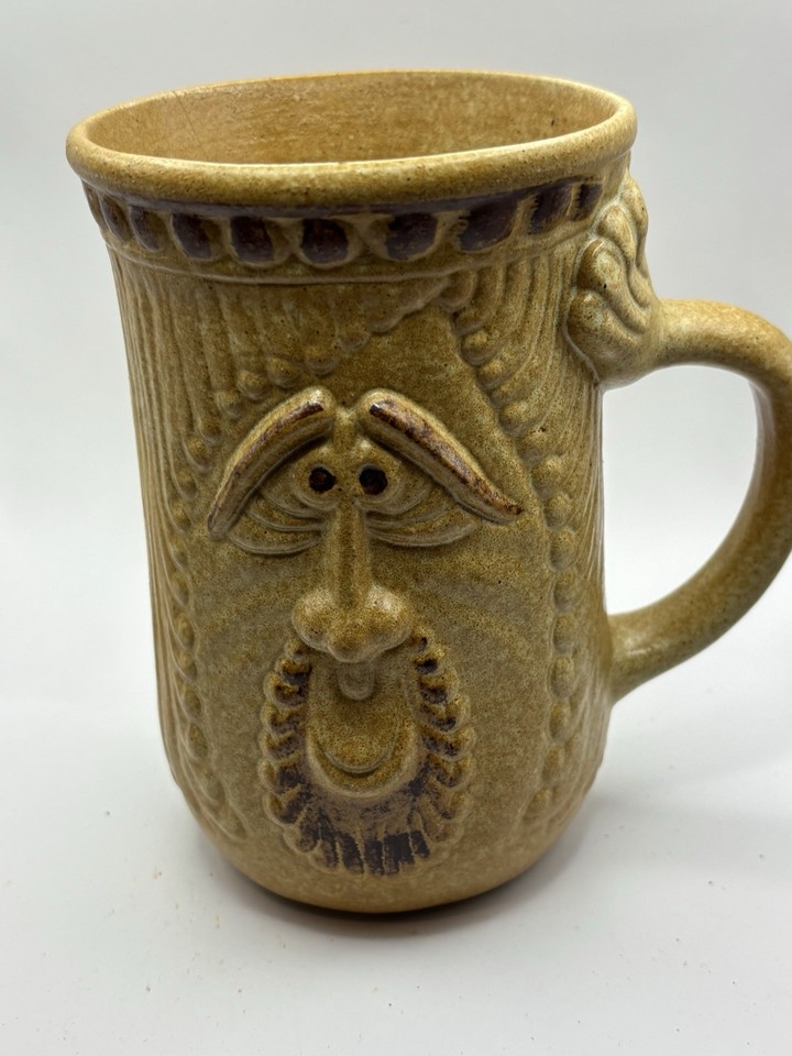 Hand-thrown, hand-painted face mug with wild kitsch energy — the kind of one-of-a-kind pottery you'd fight someone for at an estate sale.