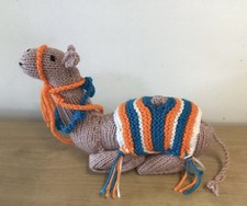 Hand Knitted Christmas Nativity Camel. Seated Wearing A Blanket.