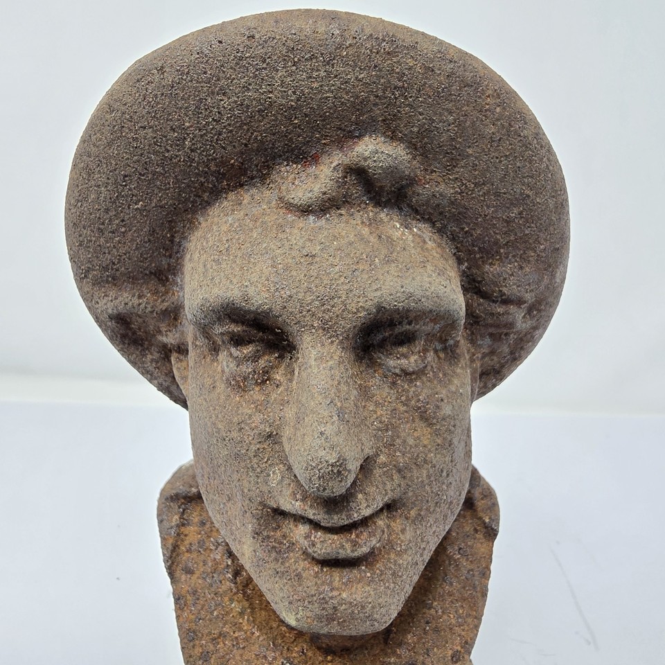 Cast iron fireplace andirons shaped like busts of men — vintage French patina, the kind of one-of-a-kind hearth piece that stops guests mid-sentence.