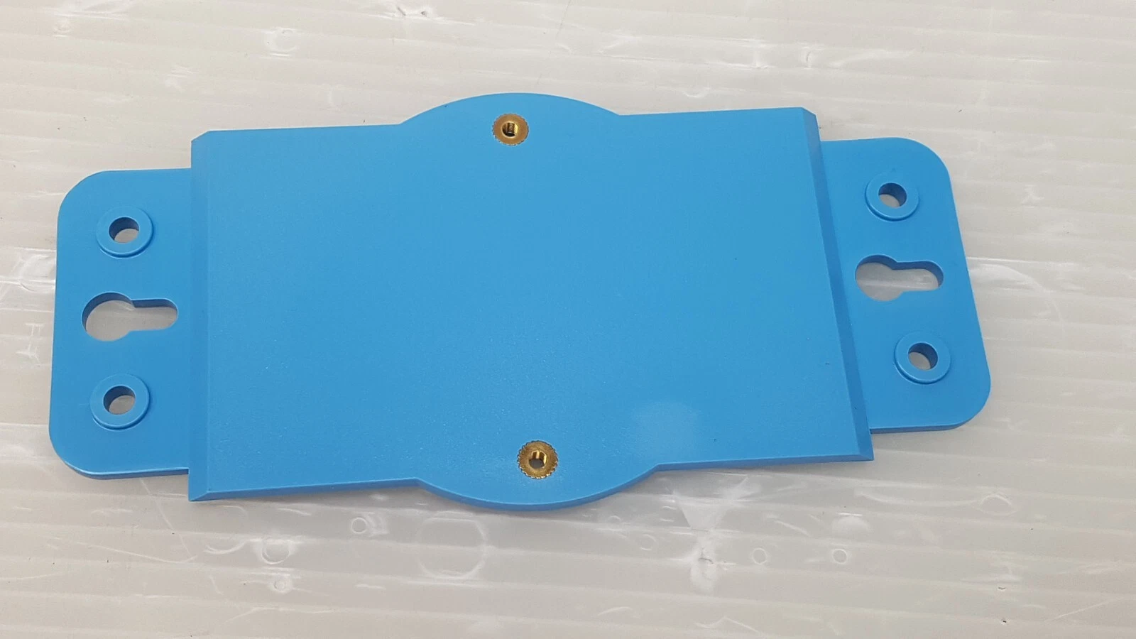 Blue ADAM mounting plate with keyhole slots and brass inserts