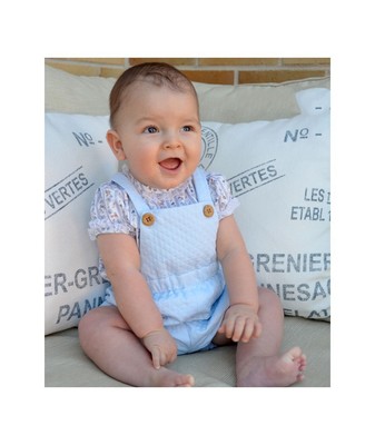 baby in dungarees