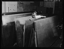 In the receiving stockroom, sheet metal is placed on carts ready for shipment