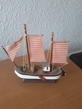 wooden fishing boat in full mast in good condition needs restoration.