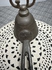 Antique metal ice cream scoop with ornate handle, marked “Gilchrist Turnkey Type,” made in USA around 1900.
