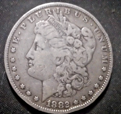 1882 O US Morgan Silver Dollar,  .900 fine, dinged rim, ave cir. condition