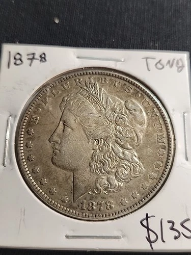 “1878 Morgan Silver Dollar, 7 Tail Feathers, VF Details.”