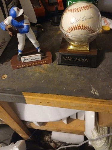 HANK AARON SIGNED BASEBALL SIGNED AT HIS DEALERSHIP IN GA. AND FIGURINE