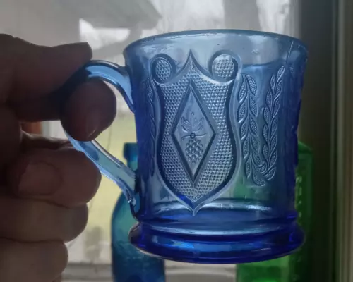 1870s COBALT BLUE GLASS MUG WITH GRAPES & SHIELDS PRESSED GLASS PATTERN