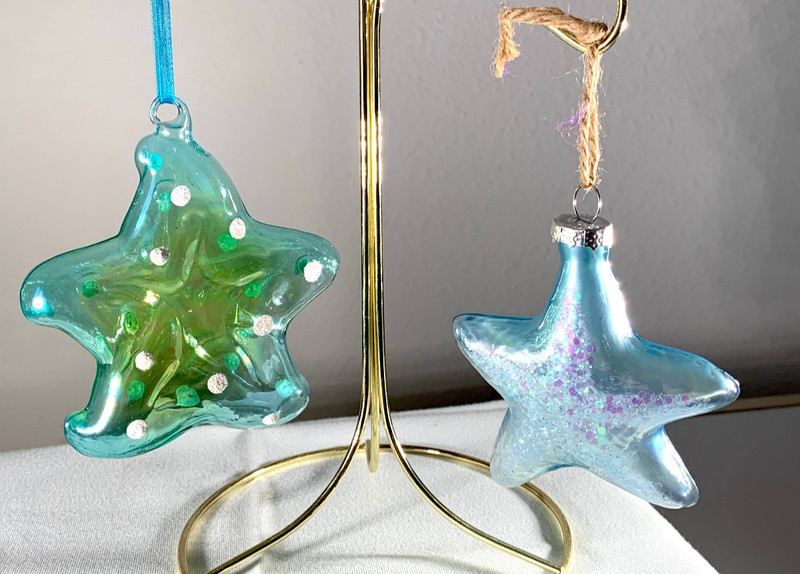TWO GLITTERY BLUE MODED GLASS STARFISH ORNAMENTS