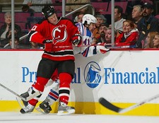 Erik Rasmussen New Jersey Devils puts his weight into Jed Or- Ice Hockey Photo