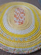 Hand Made oval Jelly Roll Rug Yellow, With  light color floral prints on.
