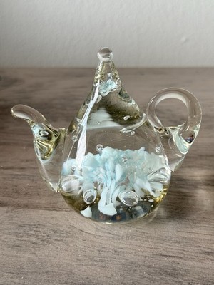 Jim Davis 1990 teapot-shaped art glass paperweight with white floral inclusions.