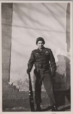WW2 Photo of Armed Soldier Standing Guard Against Wall