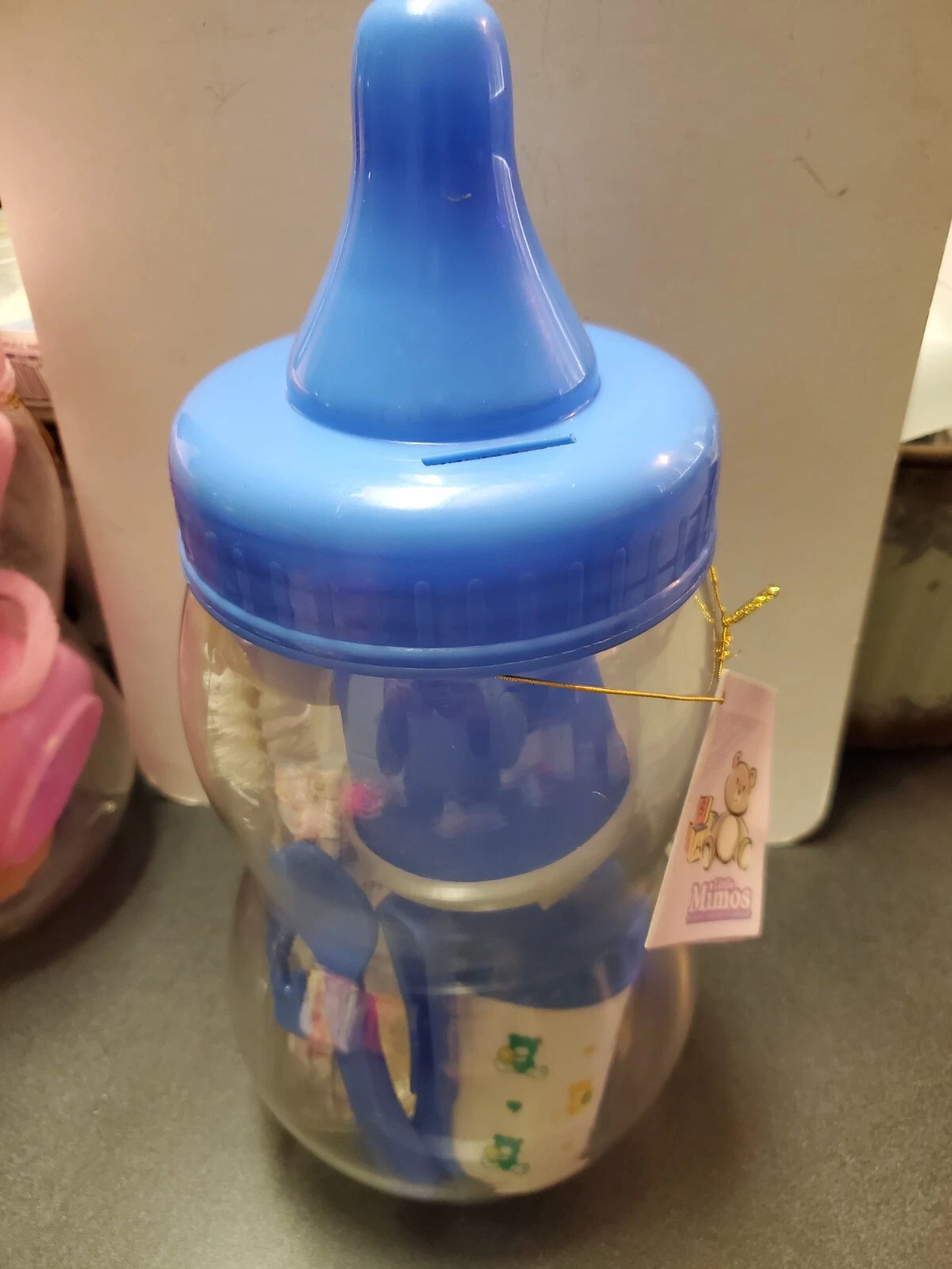Blue little mimos baby bottle piggy bank with baby bottle items for cleaning