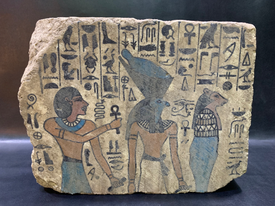 wall relief of Ramses II holding the Ankh with God Horus and Sekhmet goddess